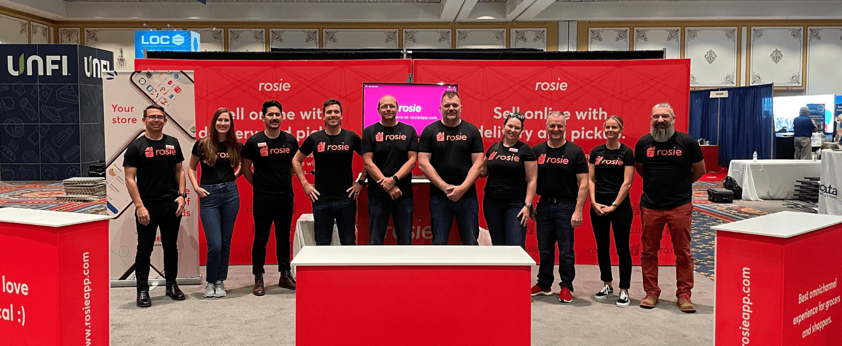 Rosie team members smiling in the Rosie booth at the NGA Show 2021