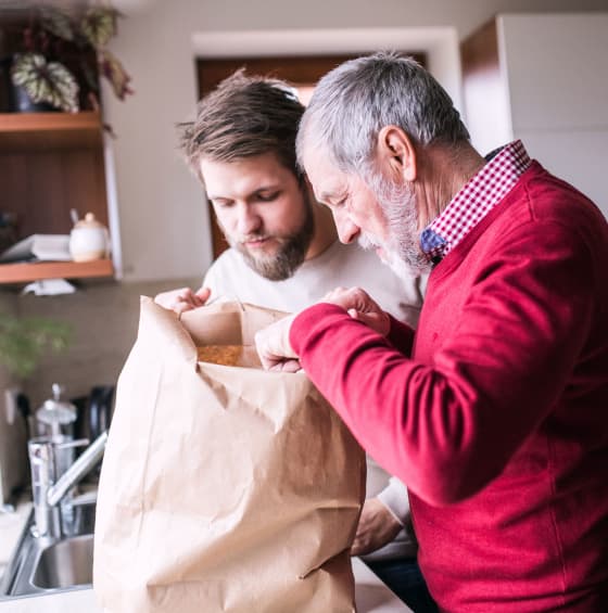 father-and-son-unpack-groceries-after-returning-from-local-grocery-store