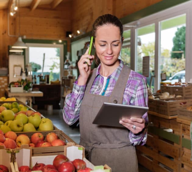 Portrait of happy female sales assistant in a grocery using tablet-rosie-application